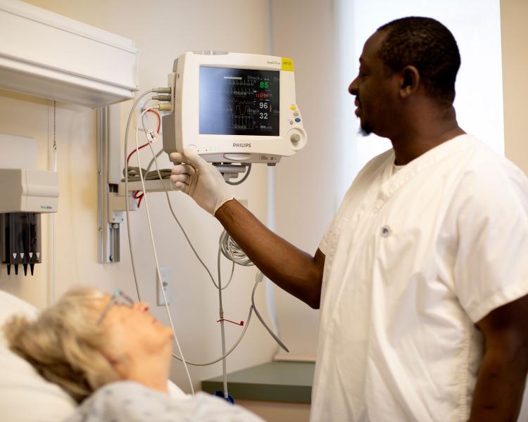 nurse monitoring patient vitals